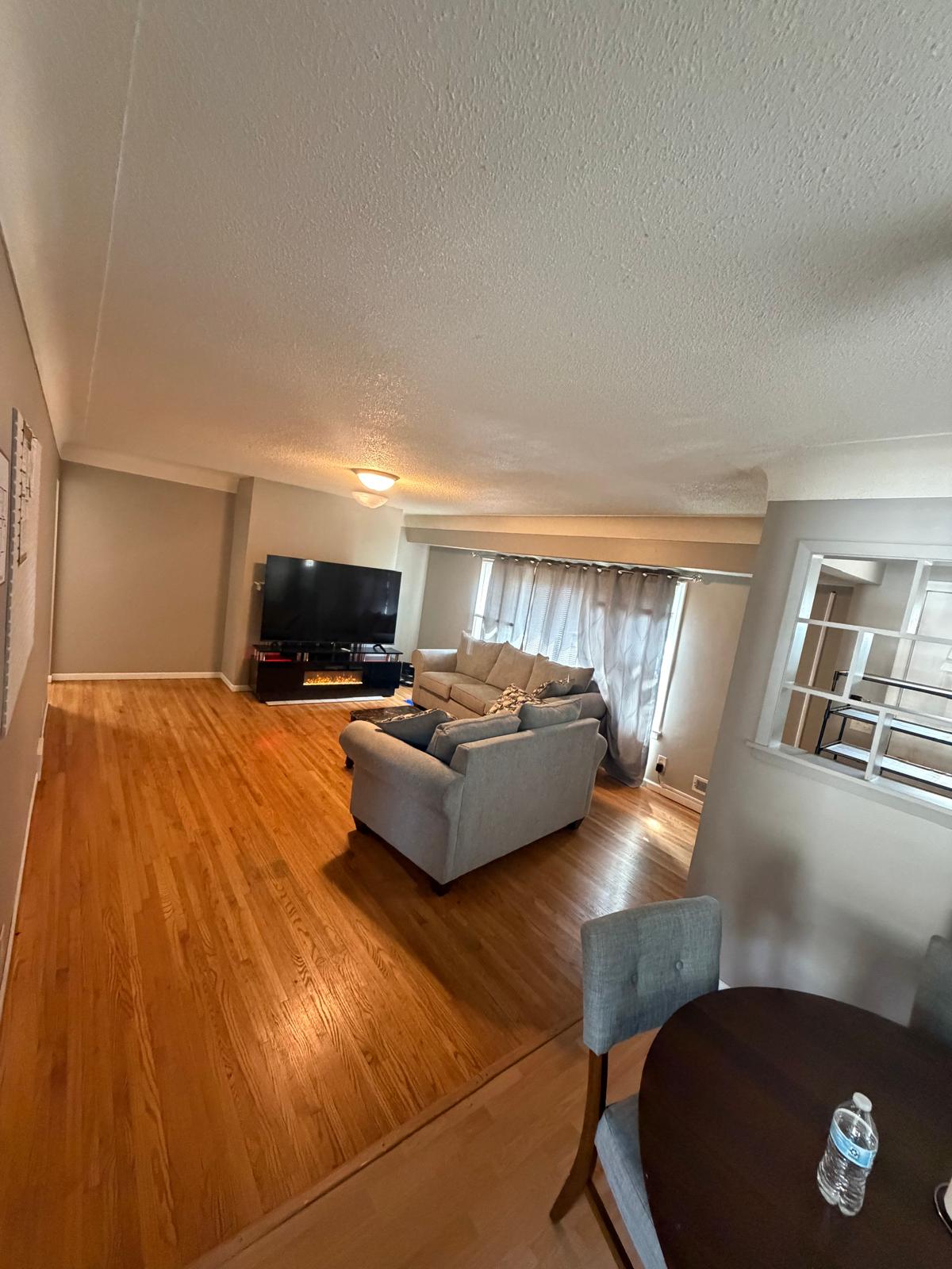 A cozy, home-like common living room with comfortable armchairs and warm lighting